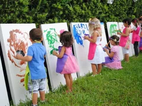 children painting on a canvas