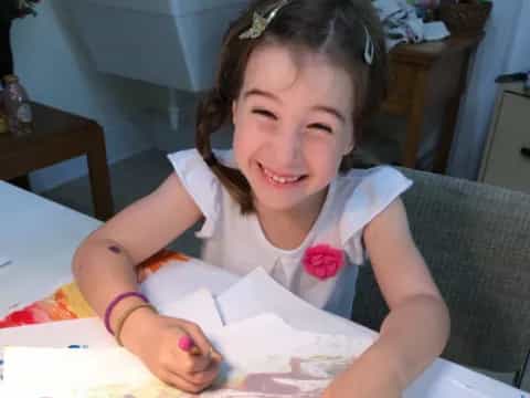 a girl sitting at a table