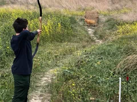 a boy holding a bow and arrow