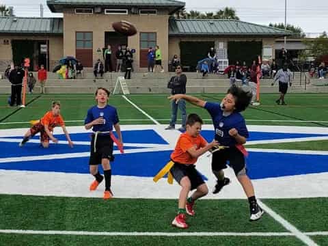 a group of kids playing football