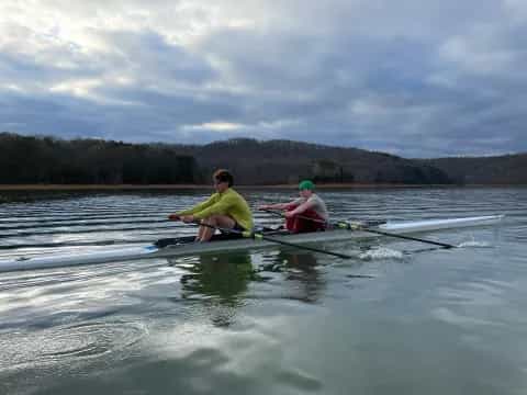 a couple of people rowing a boat