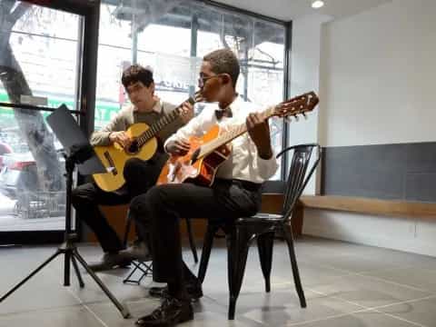 a couple of men playing guitars