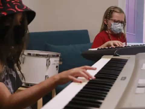 a woman playing a piano
