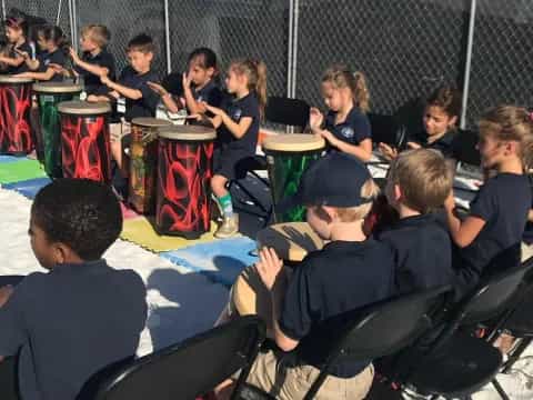 a group of children playing drums