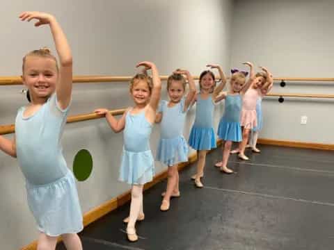 a group of girls in blue dresses