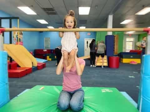a girl standing on a woman's back