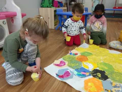 children painting on a table