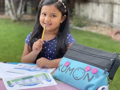 a girl sitting at a table