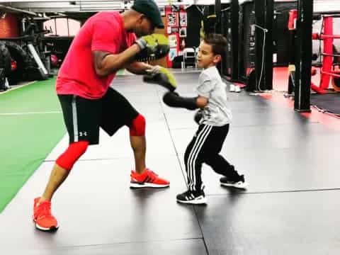 a person and a boy in a gym