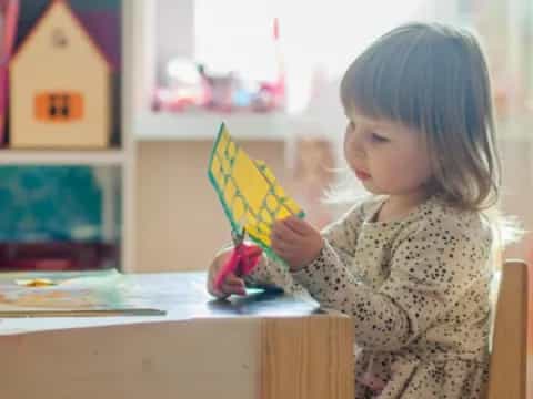 a little girl holding a kite