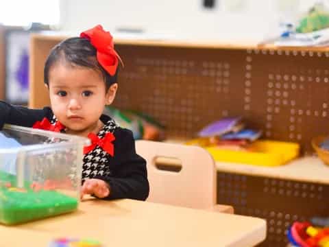a baby sitting at a table