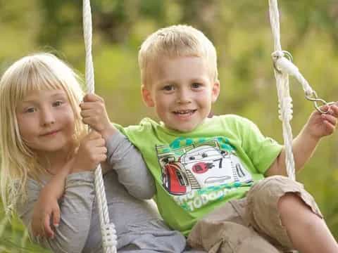 a boy and girl holding a string
