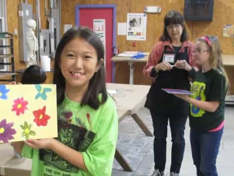 a group of girls holding a flag