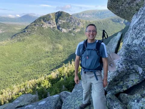 a man standing on a rocky hill