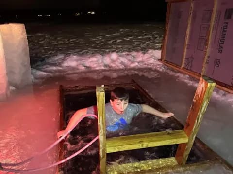 a boy sitting in a wooden bench