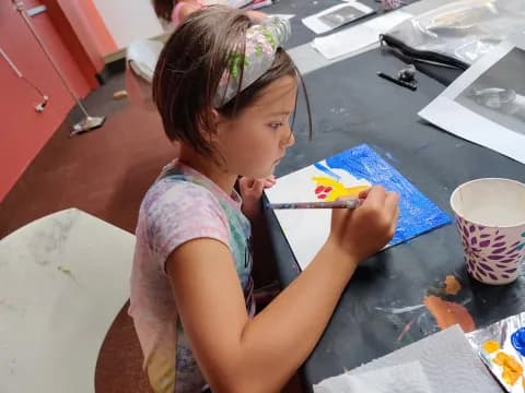 a girl painting on a table