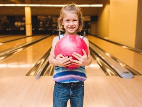 a child holding a ball