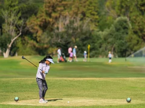 a kid swinging a golf club