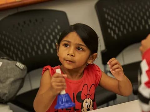 a girl sitting at a table