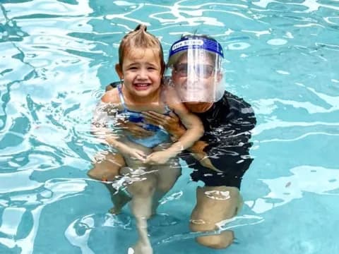 a boy and a girl in a pool