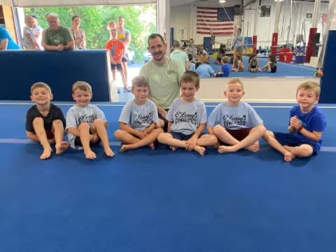 a group of kids sitting on a mat