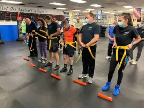 a group of people holding brooms
