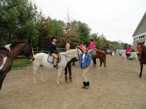 a group of people riding horses