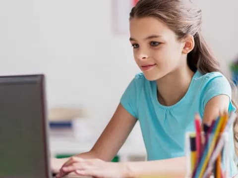 a young girl using a laptop