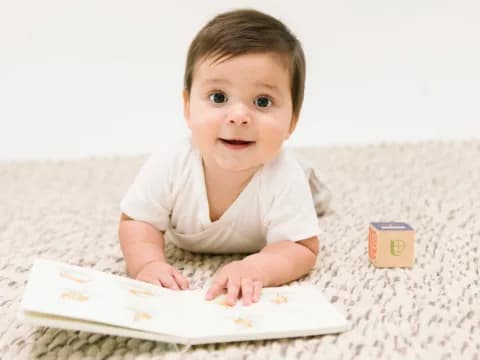 a baby lying on a bed
