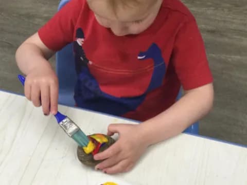 a boy painting on a table