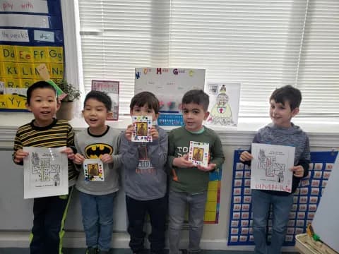 a group of boys holding up a sign