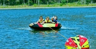 a group of people in a raft on a lake