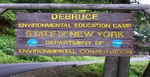 a sign on a wooden fence