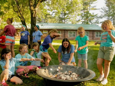 a group of people around a fire