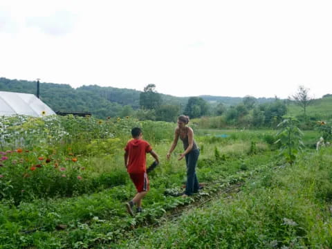 two people walking in a field