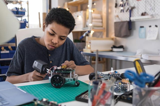 a young boy working on a toy car