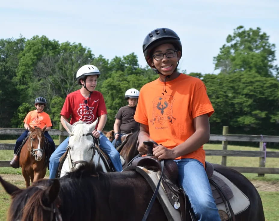 a group of people ride horses
