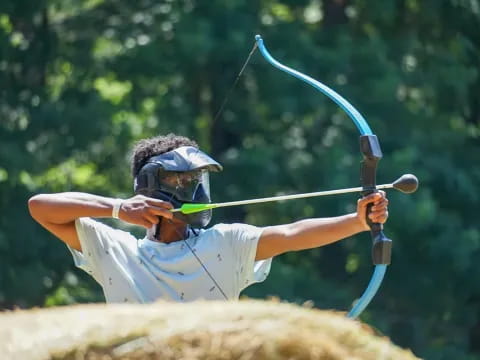 a person shooting a bow and arrow