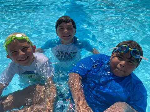 a group of kids in a pool
