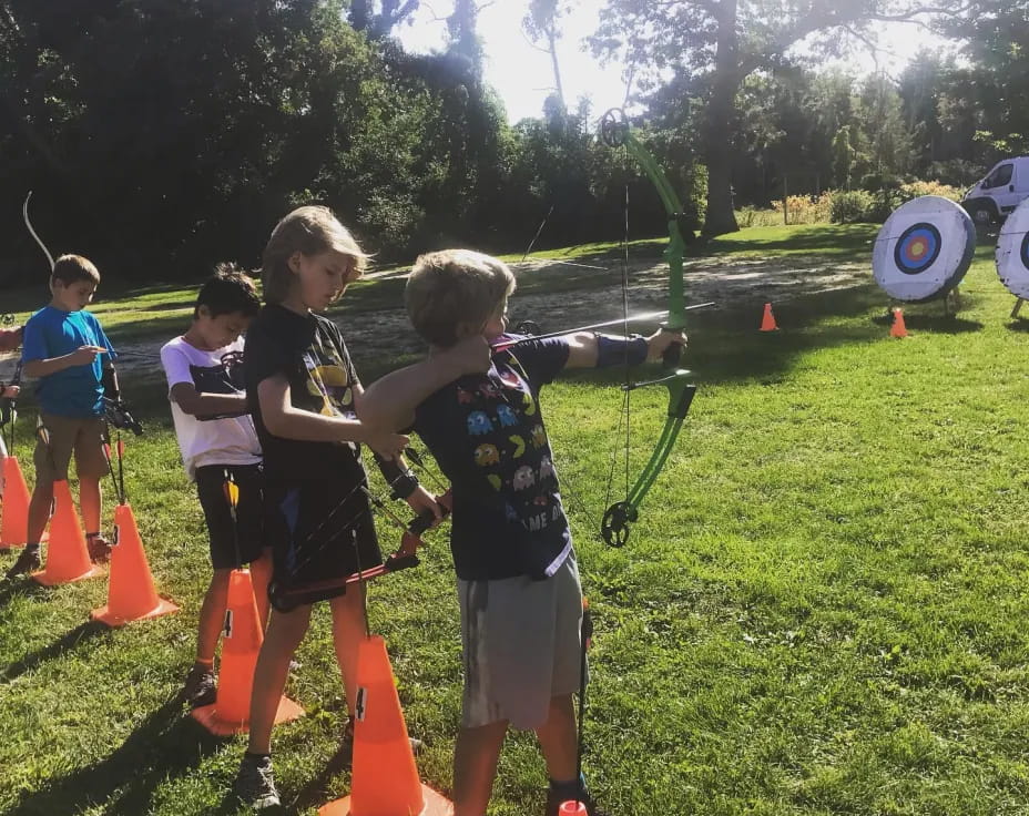 a group of kids playing with a toy