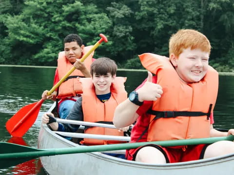 a group of boys in a canoe