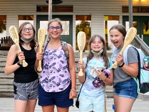 a group of people holding sticks