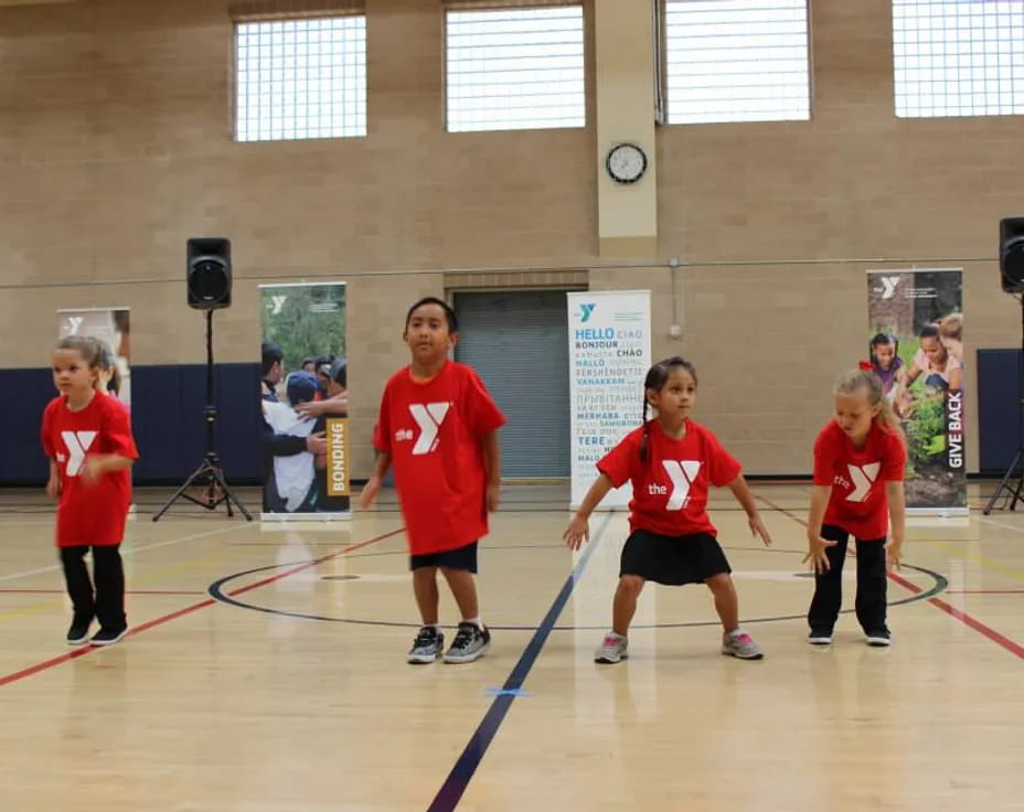 a group of kids in red shirts