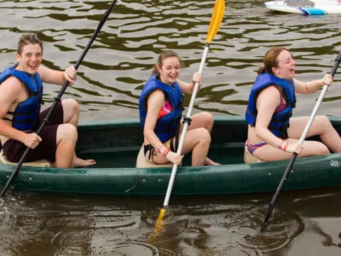 a group of people rowing a boat