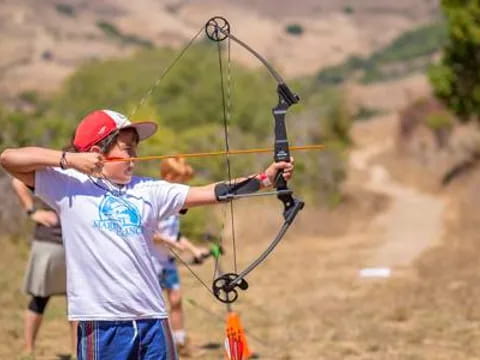 a person shooting a bow and arrow