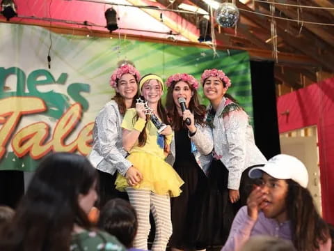 a group of women singing on stage