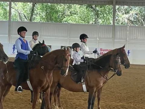a group of people riding horses