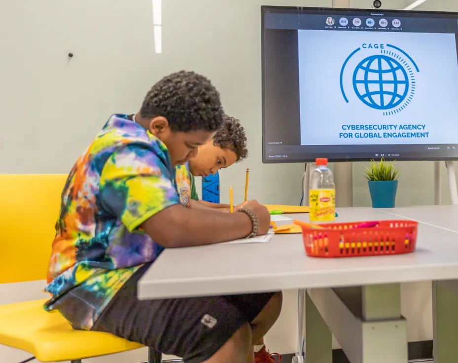a young boy sitting at a table