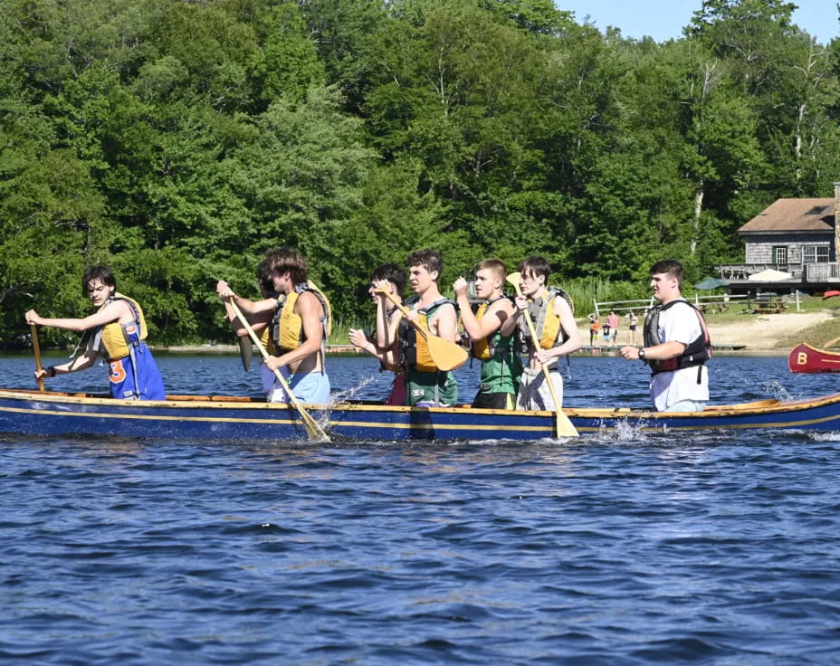 a group of people rowing a boat