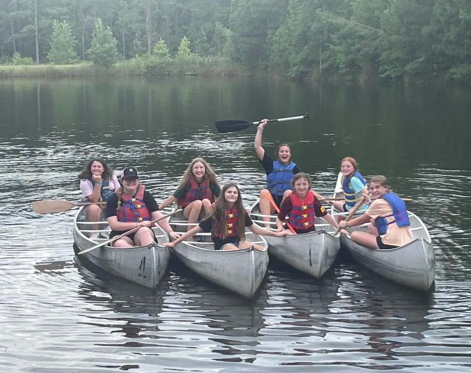 a group of people rowing a boat